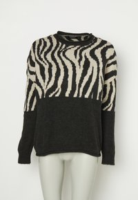 Pull noir et beige à motif zébré avec manches longues et col rond, présenté sur un mannequin.