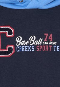Navy hoodie with a blue drawstring; features an embroidered letter "C" in red and white, and printed text: "Base Ball 74 SAN DIEGO CREEKS SPORT TEA."