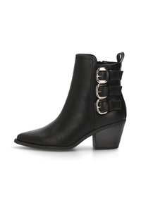 Botín de cuero negro hasta el tobillo con punta afilada, tres correas decorativas con hebilla en el costado y un tacón ancho para mayor altura.