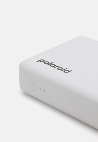 Polaroid device, rectangular, white plastic exterior, featuring a power button and three indicator lights on the front.
