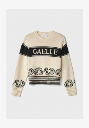 Maglione beige a maglia con strisce nere e la parola "GAELLE." Presenta motivi paisley all'orlo e polsini a coste. Design cropped.