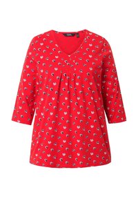 Rotes Tunika-Top mit V-Ausschnitt, 3/4-langen Ärmeln und kleinen floralen Mustern in Schwarz, Weiß und Marineblau. Weicher Stoff mit gefaltetem Detail.