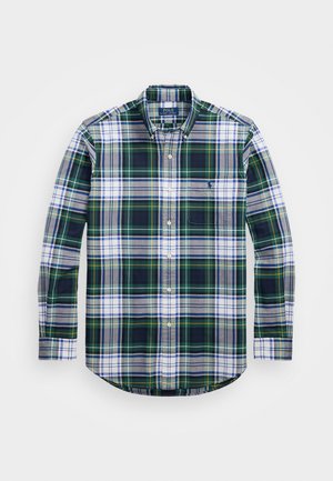 Green, blue, and white plaid long-sleeve button-up shirt with a chest pocket and curved hem. Fabric has a soft texture. Polo logo on pocket.
