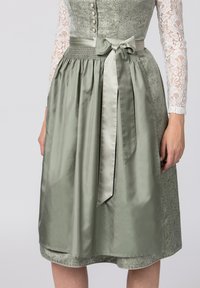 Grünes Satin-Kleid mit Spitzensäumen, gerafftem Taillenbund und einer Schleifendetail. Verfügt über kunstvolle Muster auf dem Oberteil und dem Saum.