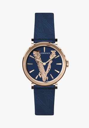 Versace watch featuring a rose gold case, dark blue dial with a raised V design, and a textured blue leather strap.