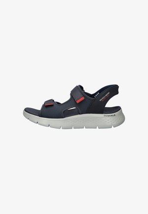 Black sporty sandal with two adjustable straps, cushioned white sole, and open heel, labeled Skechers Go Walk Slip-Ins.