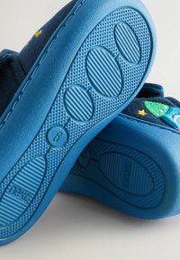 Blue toddler slippers with textured soles, size 6, featuring embroidered rockets and stars on the upper fabric.