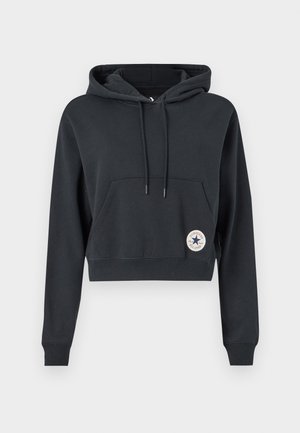 Sweat à capuche noir court en mélange de coton, avec une poche à l'avant et un patch rond avec un logo étoile sur le côté gauche.