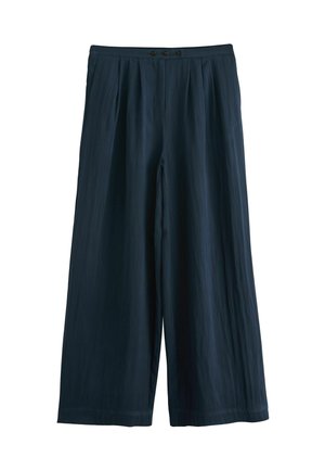 Široké kalhoty tmavě námořnické barvy, vyrobené z lehkého materiálu. Obsahují sklady na přední straně, dva knoflíky v pase a hladkou textura.