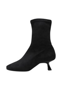 Black suede ankle boot with a pointed toe, fitted upper, and a unique angled heel. Smooth texture and minimalist design.