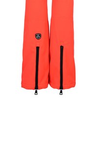 Heldere oranje skibroek met zwarte ritsen aan de onderkant, voorzien van een logopatch aan de voorkant, gemaakt van flexibel, weerbestendig materiaal.