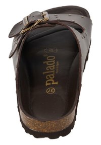 Brown leather sandal with a wide strap, a gold-tone buckle, and decorative studs. Cork footbed and textured outsole for traction.