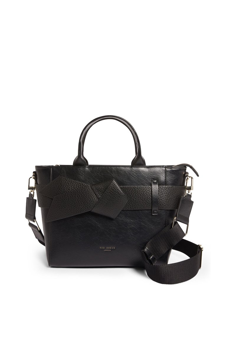 Μαύρη δερμάτινη τσάντα χειρός με υφή, που διαθέτει λουρά κι με κόμπους, ανθεκτικές λαβές και ρυθμιζόμενο λουρί ώμου.