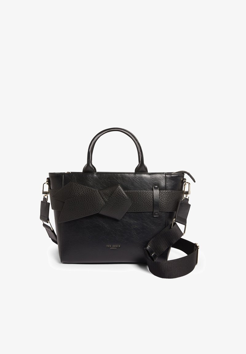 Zwarte leren handtas met een gestructureerde afwerking, voorzien van een geknoopt banddetail, stevige handgrepen en een verstelbare schouderriem.