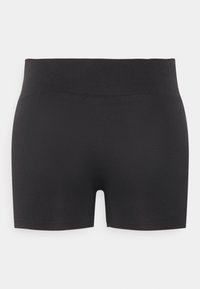 Black athletic shorts made from a stretchy material, featuring a fitted design, seamless waistband, and a mid-thigh length style.