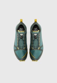 Green and gray trail shoes with a textured upper, yellow accents, and a secure lace system. Features a pull tab for easy wear.