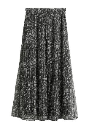 Černá sukně s bílými puntíky, skladovaný design, elastický pas a délka ke kolenům. Lehce průsvitný materiál dodává texturu.