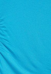 Blue fabric with fine knit texture and slight wrinkles, evenly lit with no visible objects or patterns.