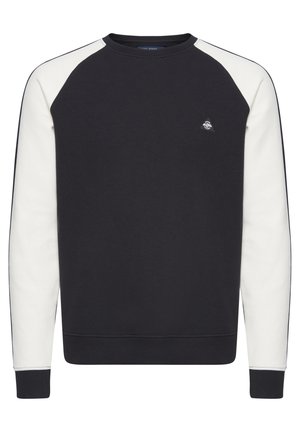 Tumepruun dressipluus kreemivärvi raglanvarrukatega, soonikuga kaelus ja varrukas, millel on väike logo rinnal. Pehme, tekstureeritud kangas.