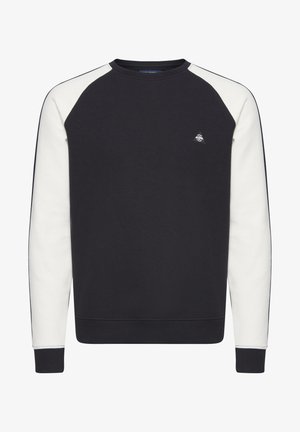 Tumepruun dressipluus kreemivärvi raglanvarrukatega, soonikuga kaelus ja varrukas, millel on väike logo rinnal. Pehme, tekstureeritud kangas.