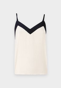Top sin mangas Ibiscous que presenta un cuerpo color crema con un escote en V azul marino. Tirantes ajustables, tejido ligero y un corte relajado.