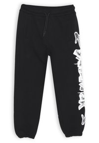 Pantaloni jogger neri con elastico in vita regolabile, caviglie a costina e testo in stile graffiti bianco sulla gamba sinistra. Due tasche laterali visibili.