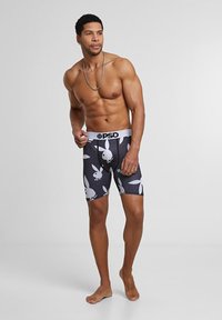 Boxer-briefs noirs avec imprimé de lapins blancs, ceinture élastique marquée "PSD" et coupe ajustée. Tissu doux avec une texture lisse.