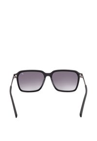 Lunettes de soleil rectangulaires noires avec des verres gris dégradés et des branches fines, vues de face sur un fond blanc.