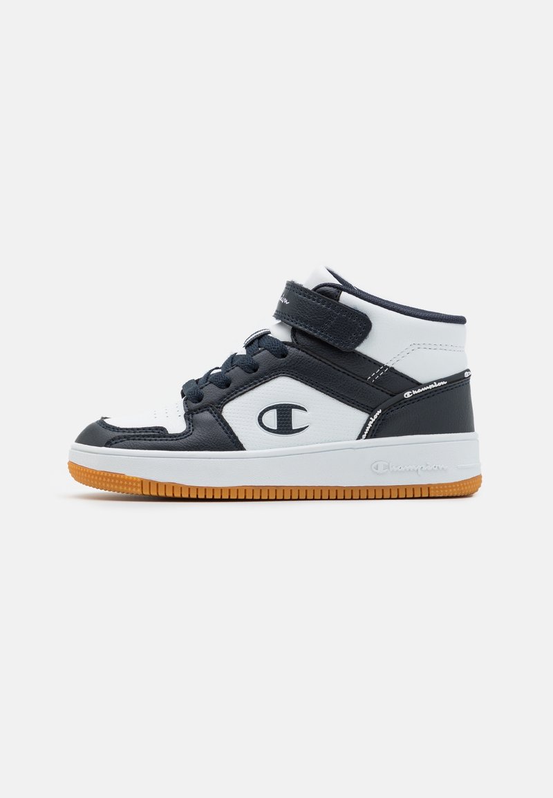 High-top sneakers featuring a white and navy leather upper, padded collar, adjustable strap, and a gum rubber sole.