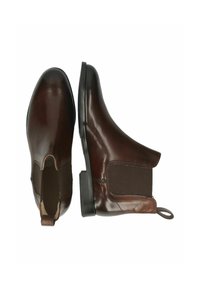 Bottines Chelsea en cuir marron avec des panneaux latéraux élastiques, bout rond et petit talon bloc. Fini lisse avec une languette au dos.