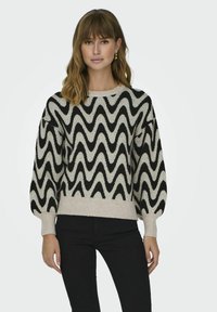 Maglione lavorato a maglia con un motivo a onde in nero e crema, con scollo rotondo e maniche a sbuffo, rifinito con un bordo a coste.