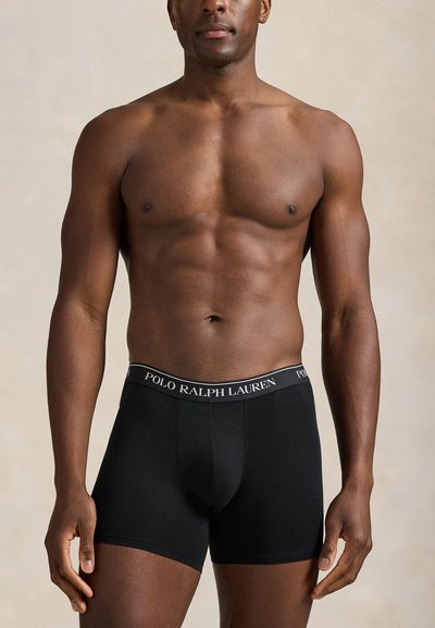 Svarta boxerbriefs med en mjuk textur, utrustade med ett kontrasterande midjeband som har texten "POLO RALPH LAUREN" i vitt.