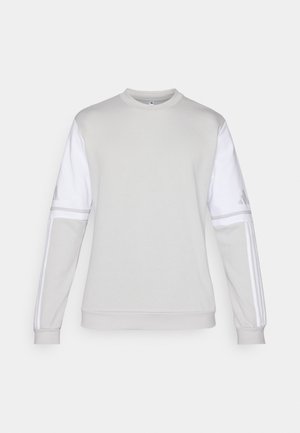 Lysegrå sweatshirt med hvide ærmer. Har ribbede manchetter og rund hals. Tre hvide striber på hver arm og logo på venstre ærme.