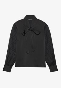 Svart långärmad blus med en sløjfa vid kragen och genomskinliga prickiga ärmar med manschetter, märkt Anna Field.