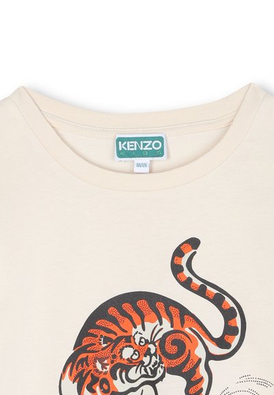 T-shirt en coton couleur crème avec un graphique de tigre noir et orange, col rond et étiquette KENZO Kids près du col.