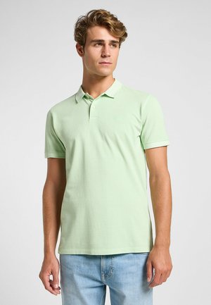 Light green cotton polo shirt with a collared neckline, short sleeves, and a subtle embroidered logo on the chest. Slim fit design.