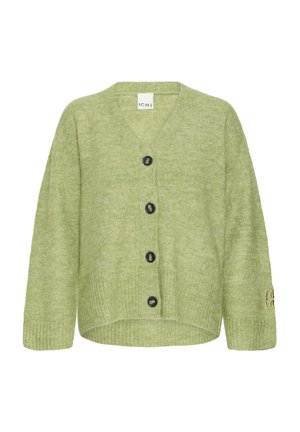 Zöld kötött kardigán V-nyakkivágással, öt fekete gombbal elöl, és bordázott mandzsettákkal. Ujján logórészlet található.