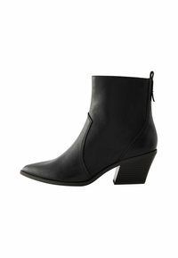 Stivaletto nero realizzato in pelle sintetica liscia, con punta affusolata e tacco a blocco spesso con un motivo testurizzato.