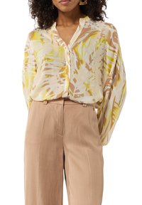 Lightweight, long-sleeve blouse in cream with yellow and brown abstract leaf pattern; features a button-front and soft, flowing fabric.