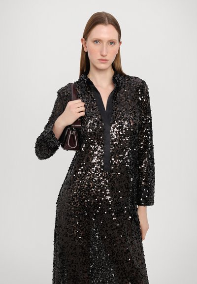 Black sequin dress with long sleeves, a collar, and a button placket. The fabric is shiny, featuring a mix of black and silver sequins.