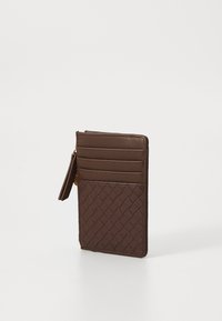 Brown leather cardholder with a woven texture, featuring four card slots and a zippered compartment. Slim design with a smooth finish.