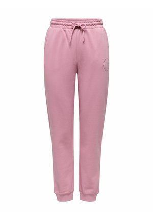 Pantaloni sport roz cu șnur, glezne cu mansete și un mic logo circular pe coapsa stângă, afișați pe fundal alb.