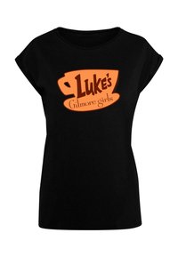 Must have lühikeste varrukatega must t-särk, millel on oranž tassigraafika, millel on pruuni fondiga tekst "Luke's" ja "Gilmore girls". Klassikaline lõige.