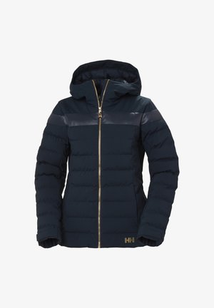 Marineblauwe gewatteerde jas met capuchon, voorzien van een gestikte textuur, gouden ritsluiting en glanzende schouderstrepen. Logo zichtbaar aan de zijkant.