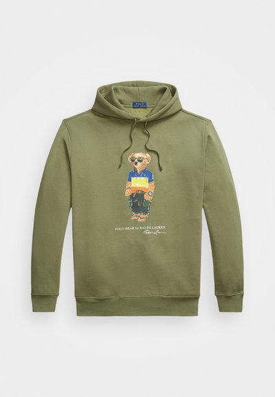 Olive green hoodie with a drawstring, featuring a colorful bear graphic in sunglasses. Material is soft, with ribbed cuffs and hem.