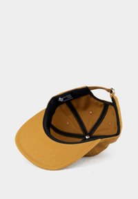 Yellow cap with a curved visor, black lining inside, and beige interior. Features metal adjustment hardware at the back and stitching accents.
