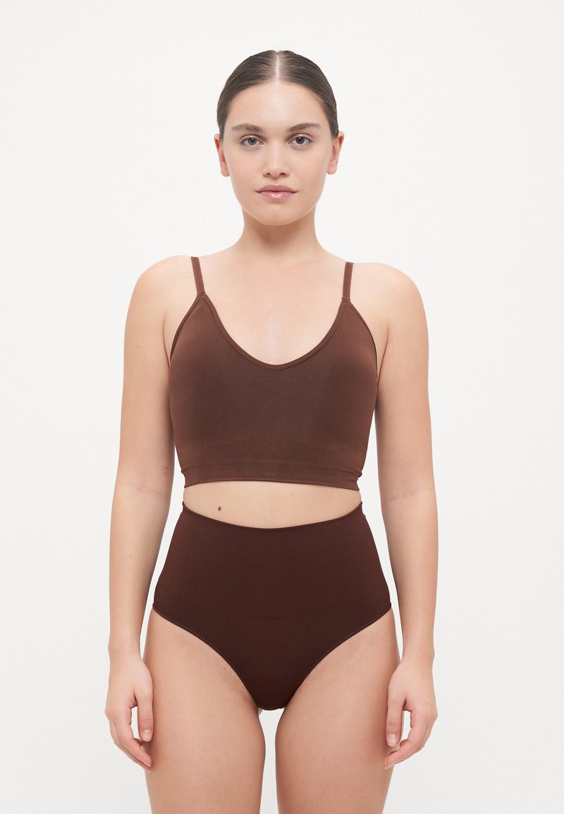 Set di crop top marrone e mutandine a vita alta. Tessuto liscio, cuciture minime, spalline regolabili e design con ritaglio sulla vita.