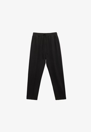 Schwarze Sweatpants mit einem elastischen Bund und Kordelzug. Mit zwei Seitentaschen und einer lockeren Passform mit glatter Textur.