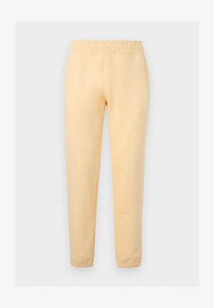 Ανοιχτό κίτρινο στενό παντελόνι φόρμας με ελαστική μέση και μανσέτες στους αστραγάλους, με διακριτικό λευκό λογότυπο Adidas trefoil στο αριστερό μηρό.