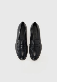 Black leather loafers with a flat sole, featuring a rounded toe and decorative strap across the front. Inside logo visible. Size 42.